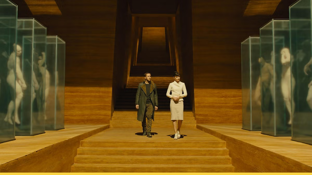 K and Luv descend into the eerie Wallace Corporation chamber lined with replicant prototypes in Blade Runner 2049