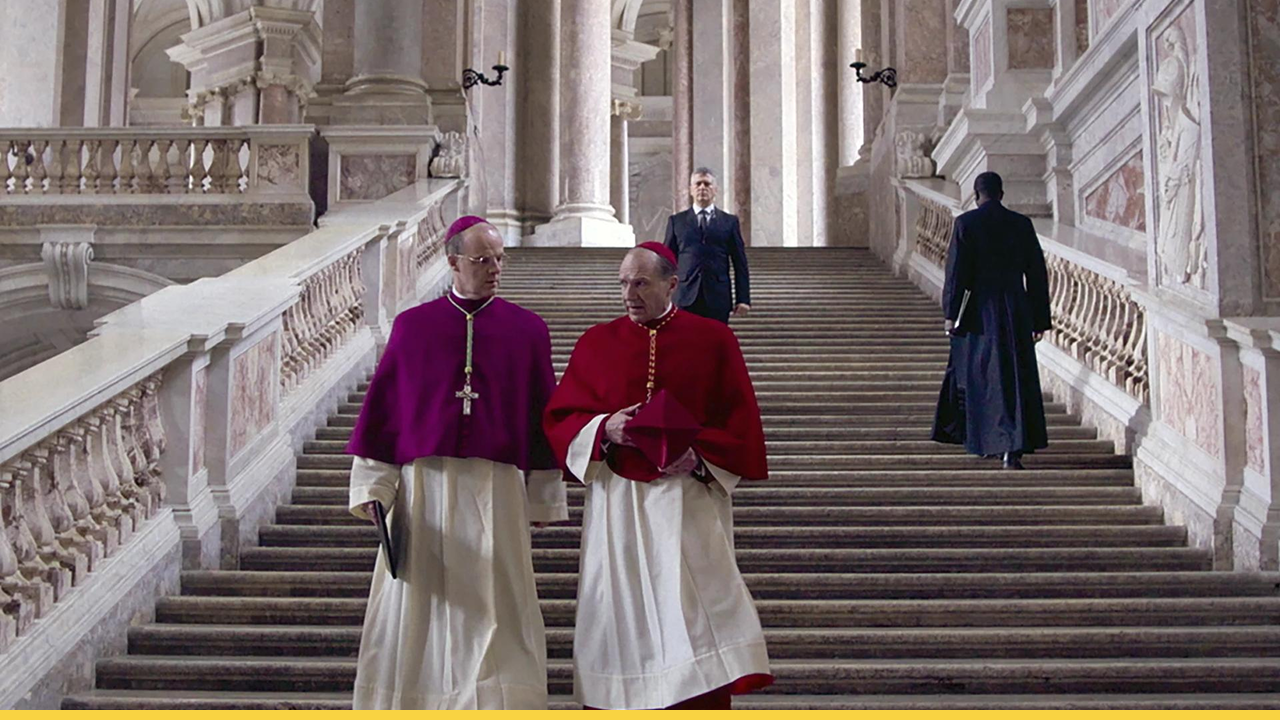 Two Cardinals walking down the stairs discussing about the conclave.