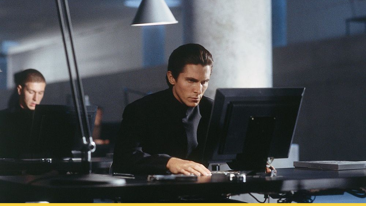 Cleric John Preston intensely studies surveillance data in a dystopian office setting from Equilibrium