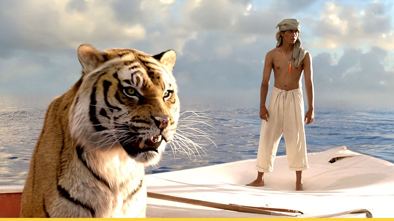 A tiger and a young man stand on a small raft in the middle of the ocean.