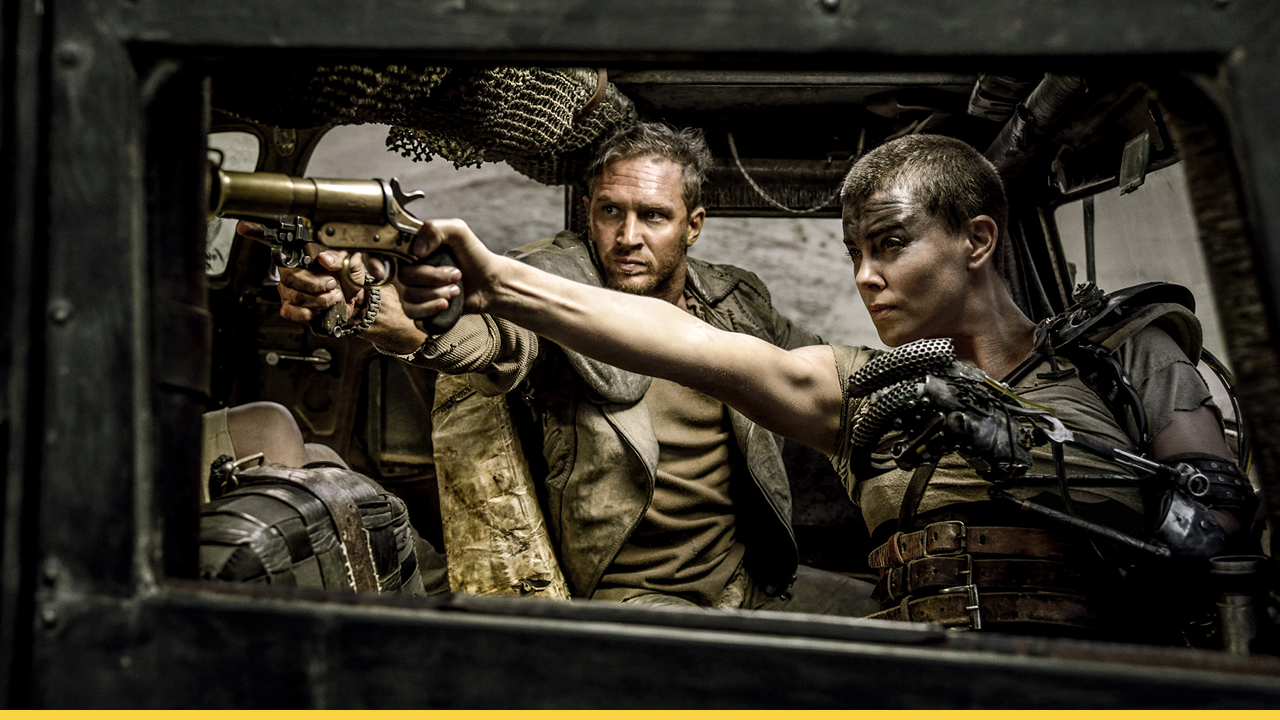 Furiosa fiercely takes aim while Max steadies her in a high-octane moment from Mad Max: Fury Road