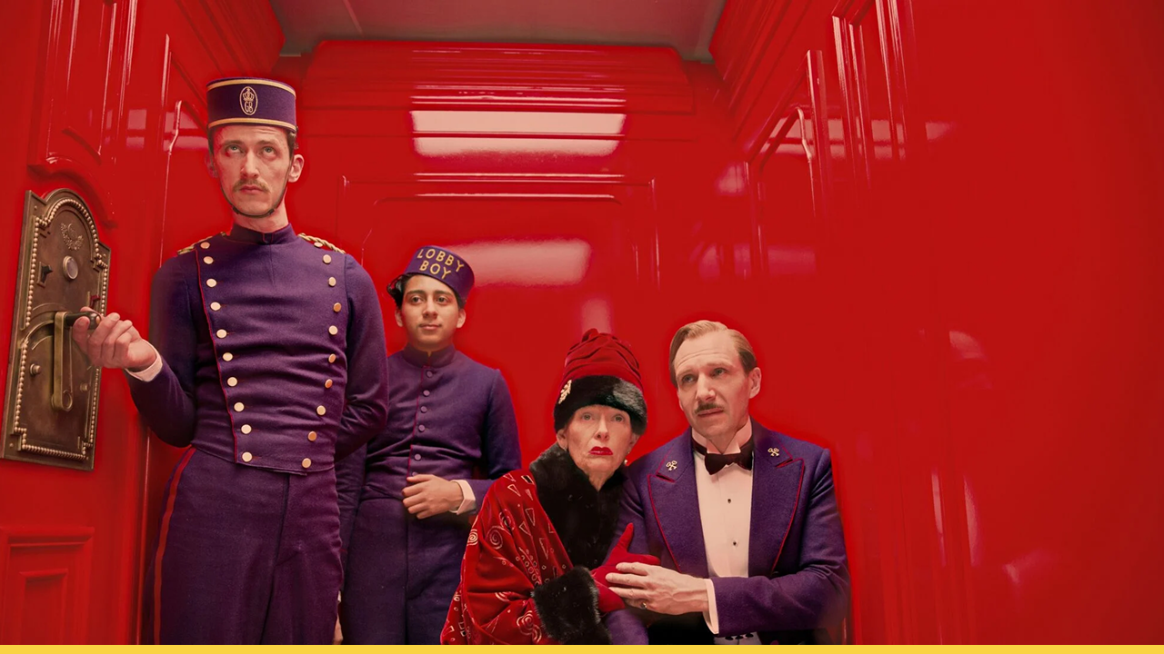 Four characters in colorful uniforms and vintage attire stand inside a bright red elevator.