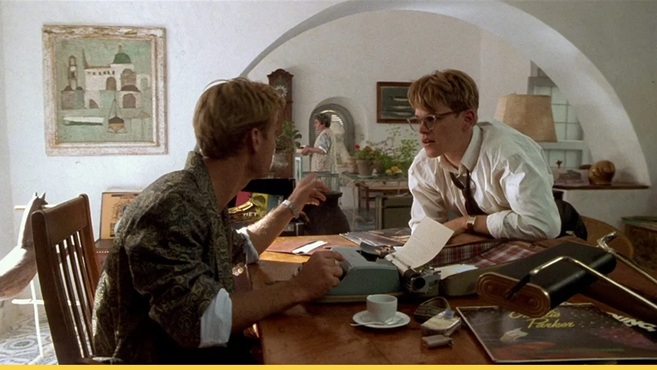 Two characters from The Talented Mr. Ripley talking at a table with a typewriter
