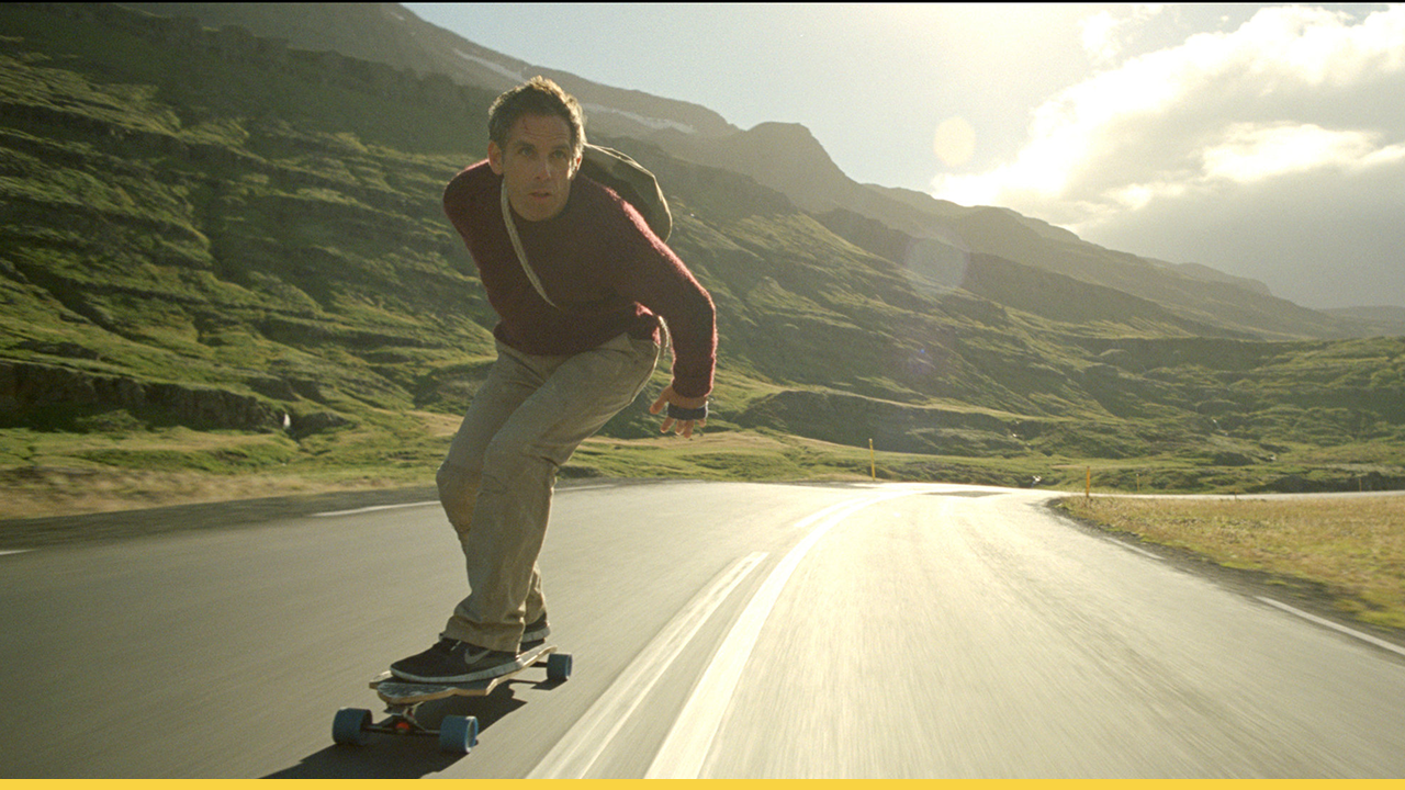 Walter Mitty skateboarding down a scenic mountain road in Iceland